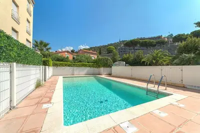 a swimming pool in the middle of a building at Entire Condo in Nice in Nice