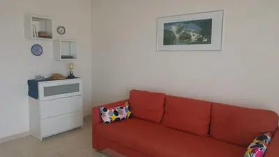 a living room with a red couch in a room at Entire Condo in Nice in Nice