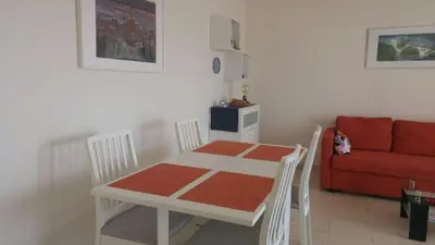 a white table and chairs in a living room with a couch at Entire Condo in Nice in Nice