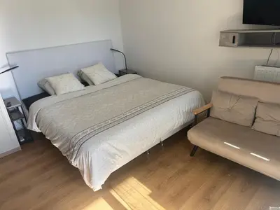 a bedroom with a bed and a couch in it at Beau Studio avec belle terrasse au centre ville de Nice in Nice