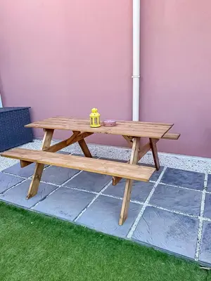 a wooden picnic table with a tea pot on top at Fabron studio et Résidence de Luxe avec Piscine in Nice