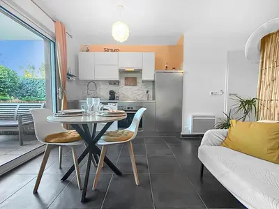 a kitchen and dining room with a table and a couch at Fabron studio et Résidence de Luxe avec Piscine in Nice