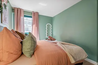 a bedroom with a bed with green walls and a window at Nice Renting - FLEURS - Luxury Stay Terrace Quiet Private Parking in Nice
