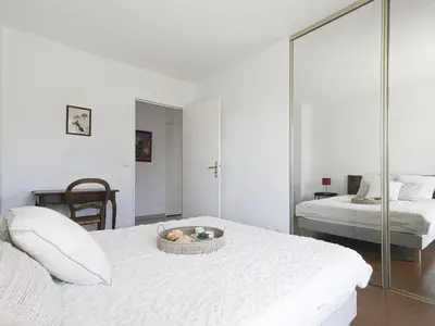 a bedroom with a bed with a basket of fruit on it at Apartment Baie Azur by Interhome in Nice