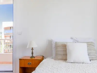 a bedroom with a bed and a table with a lamp at Apartment Baie Azur by Interhome in Nice