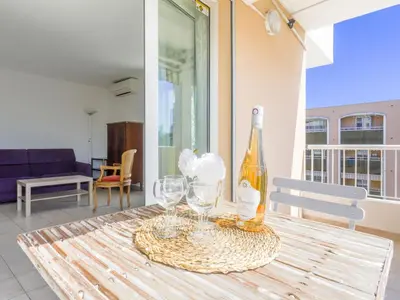 a bottle of wine sitting on a table with glasses at Apartment Baie Azur by Interhome in Nice