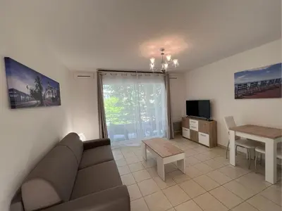a living room with a couch and a table at Sunny studio with Terrace in Nice