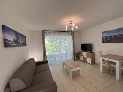 a living room with a couch and a table at Sunny studio with Terrace in Nice