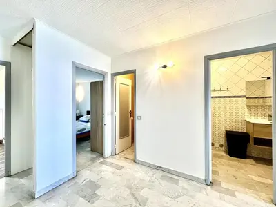 a room with two doors leading to a bedroom at Spacious 2P Terrace with sea view in Nice