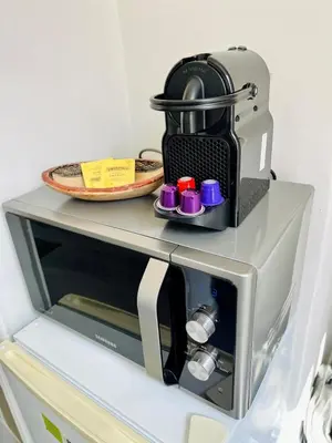 a microwave oven with a plate on top of it at Charmant studio moderne équipé à Nice in Nice