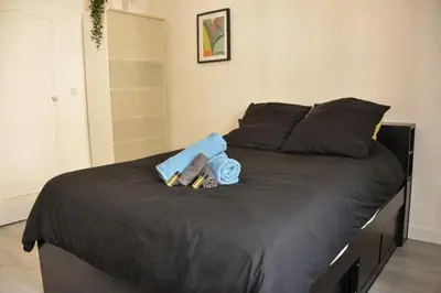 a bed with a stuffed animal on top of it at Charmant studio moderne équipé à Nice in Nice