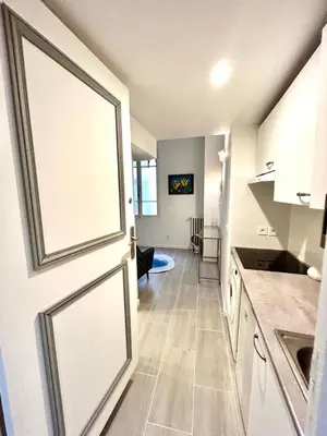 a kitchen with a sliding door and a living room at City Center Studio - 1 min Train Station & Main Street in Nice