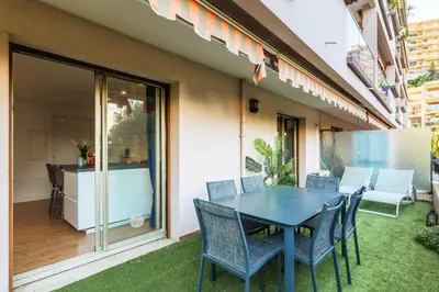 a patio with a table and chairs and a kitchen at Grand 2 pieces et belle terrasse ensoleillee in Nice
