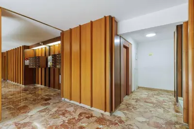 a hallway with wooden panels in a room at Grand 2 pieces et belle terrasse ensoleillee in Nice