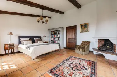 a bedroom with a bed and a fireplace at Magnifique villa avec vue mer panoramique in Nice
