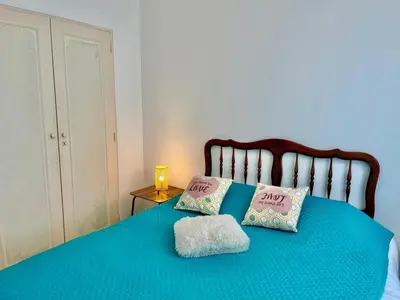 a blue bed with two pillows on top of it at Les Bleuets in Cagnes-sur-Mer
