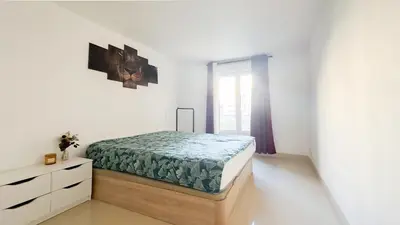 a bedroom with a bed and a dresser in it at nice two rooms in Nice