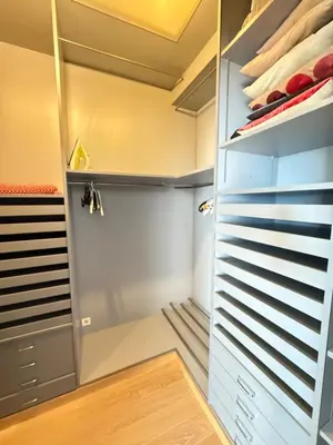 a walk in closet with gray cabinets and a glass door at Les Jardins de Villefranche in Villefranche-sur-Mer