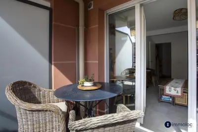 a small table and chairs on a balcony with a table and chairs at Air-conditioned apartment near Libération district in Nice