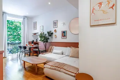 a living room with a white couch and a table at New! Remodeled Appartement in the Heart of Nice, Beach 3 min, 2BR, AC, Elevator, Amazing little terrace, Best Location! in Nice