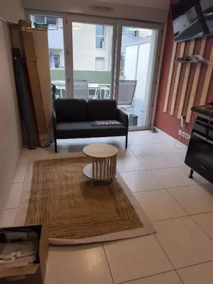 a living room with a couch and a coffee table at Studio calme et paisible, climatisé avec terrasse au dernier étage, 100m du tramway et 20 min de la promenade des anglais in Nice