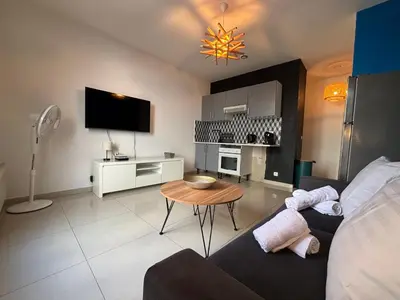a living room with a couch and a table at Studio 2 Libération proche tram in Nice