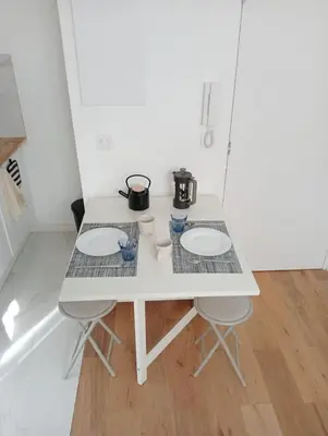 a white table with two pots on top of it at Charming Studio in the Heart of Nice in Nice