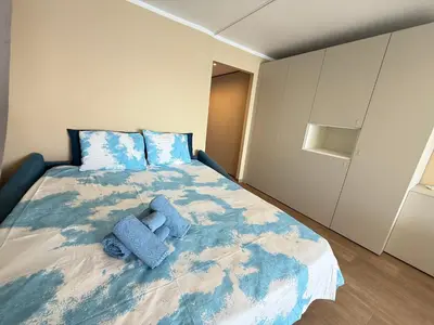 a bedroom with a large bed with blue pillows at Azur Promenade in Nice
