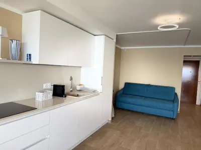 a kitchen with a blue couch in a room at Azur Promenade in Nice