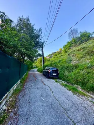 a car parked on the side of a road at Appartement Jardin 10mn centre in Nice