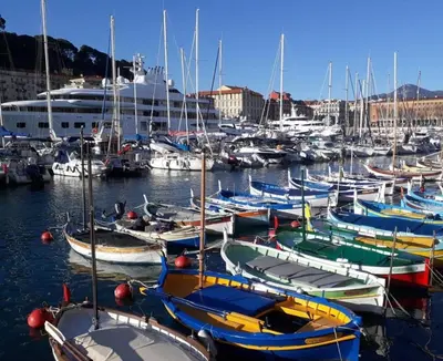 a bunch of boats docked in a harbor with a cruise ship at Tribord Holiday House in Nice