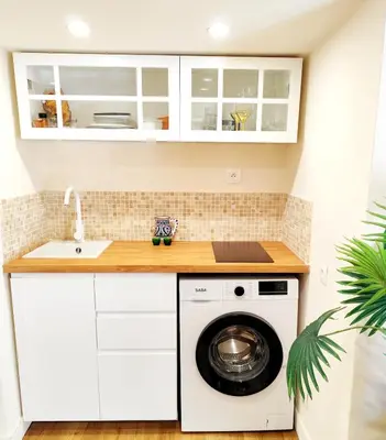 a kitchen with a washing machine and a sink at Tribord Holiday House in Nice