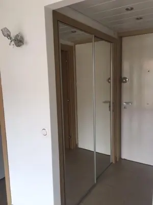 a glass door in a room with a mirror at Studio et ses deux piscines in Nice