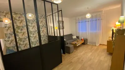 a living room with a couch and a chair at Appartement proche plage, aéroport, tram in Nice