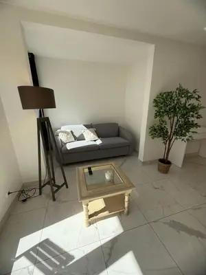 a living room with a couch and a coffee table at Magnifique 3 pièces à 100m de la mer in Nice