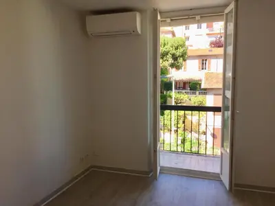 an empty room with an open door to a balcony at Studio tout équipé in Nice