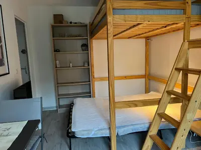 a bunk bed in a room with a ladder at Studio tout équipé in Nice