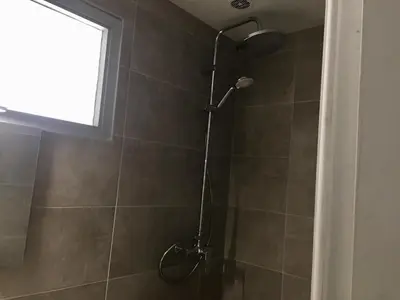 a shower with a shower head in a bathroom at Studio tout équipé in Nice