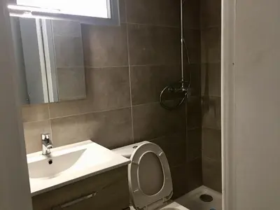 a bathroom with a sink and a toilet and a mirror at Studio tout équipé in Nice