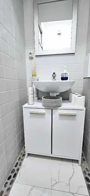 a white bathroom with a sink and a mirror at Top Floor with Sea View, Clim and Veranda in Nice