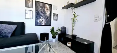 a living room with a couch and a glass table at Top Floor with Sea View, Clim and Veranda in Nice