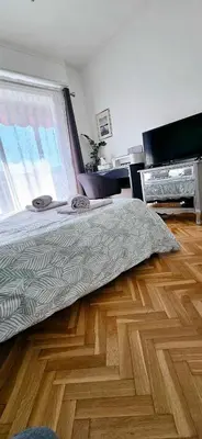 a bedroom with a bed and a wooden floor at Top Floor with Sea View, Clim and Veranda in Nice