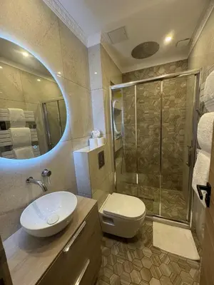 a bathroom with a toilet and a sink and a shower at 2P place massena in Nice