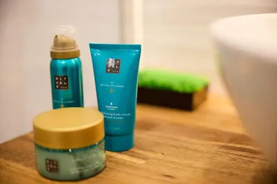 a bottle of sunscreen and a bottle of hair products on a table at Suite romantique - Carré d'Or Nice proche de la mer in Nice