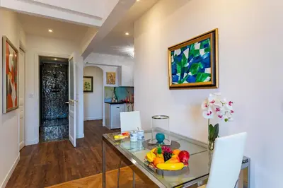 a dining room with a glass table and a vase of flowers at LE ROYAL AP4456 by Riviera Holiday Homes in Nice