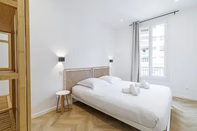 a white bedroom with a bed and a window at Large & Confort 2 Bdr Renovated in Nice