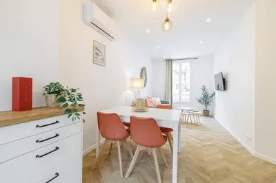 a kitchen and dining room with a white table and chairs at Large & Confort 2 Bdr Renovated in Nice