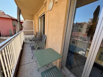 a balcony with a table and chairs on a balcony at Cozy Studio Apt with balcony close to Garibaldi in Nice