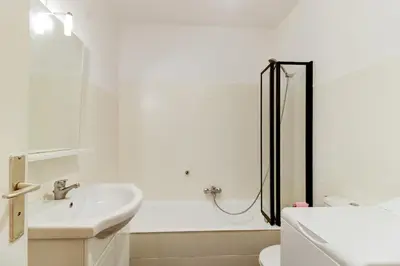 a white bathroom with a sink and a shower at Cozy Studio Apt with balcony close to Garibaldi in Nice