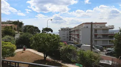 a view of a city with a street light and buildings at Residence les Lauriers in Nice